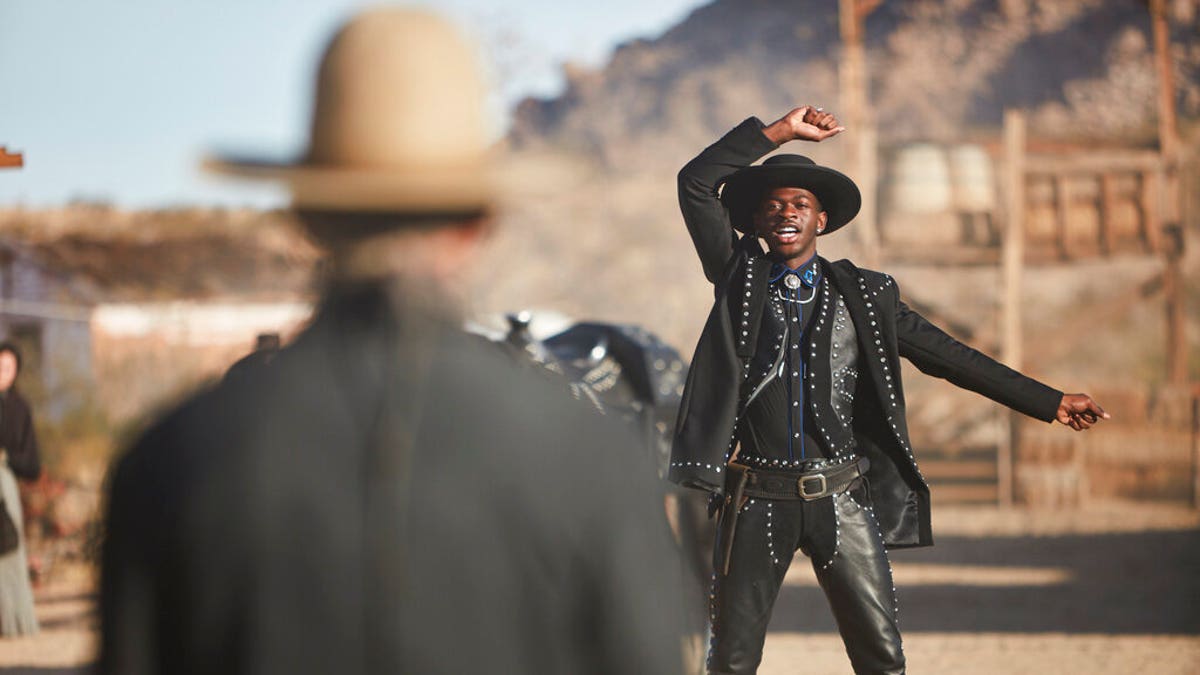 This undated photo provided by Doritos shows Lil Nas X, right, and Sam Elliott in a scene from the company's 2020 Super Bowl NFL football spot. 