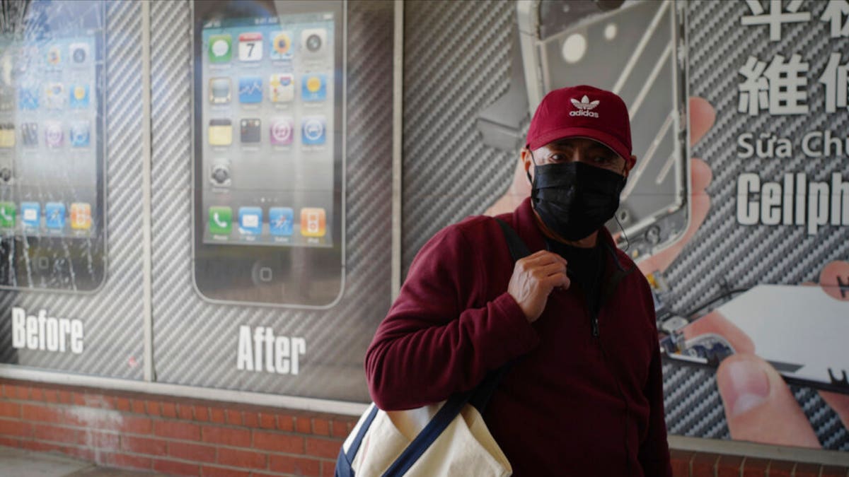 A man wears a protective mask while shopping in Alhambra, Calif., Friday, Jan. 31, 2020. 