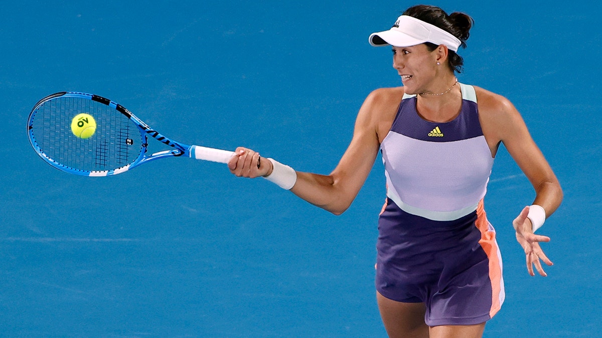 Spain's Garbine Muguruza makes a forehand return to Sofia Kenin of the U.S. during the women's final at the Australian Open tennis championship in Melbourne, Australia, Saturday, Feb. 1, 2020. (AP Photo/Andy Wong)
