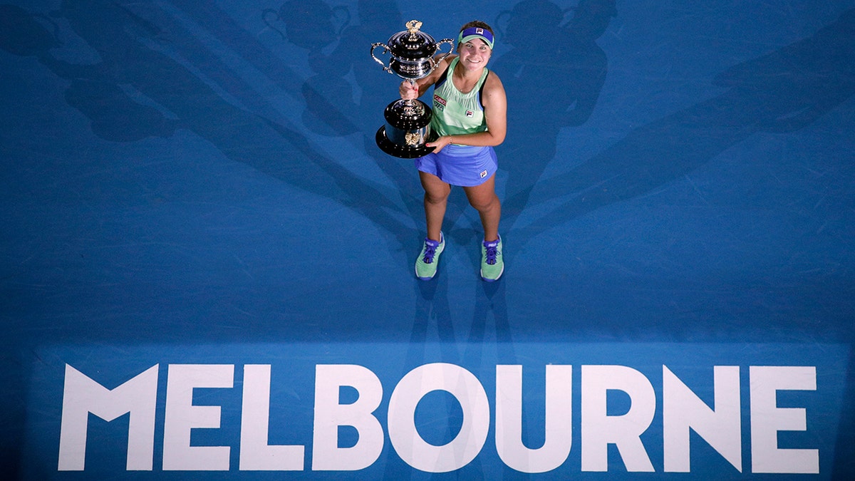 Sofia Kenin of the U.S. holds the Daphne Akhurst Memorial Cup after defeating Spain's Garbine Muguruza in the women's singles final at the Australian Open tennis championship in Melbourne, Australia, Saturday, Feb. 1, 2020. (AP Photo/Andy Wong)