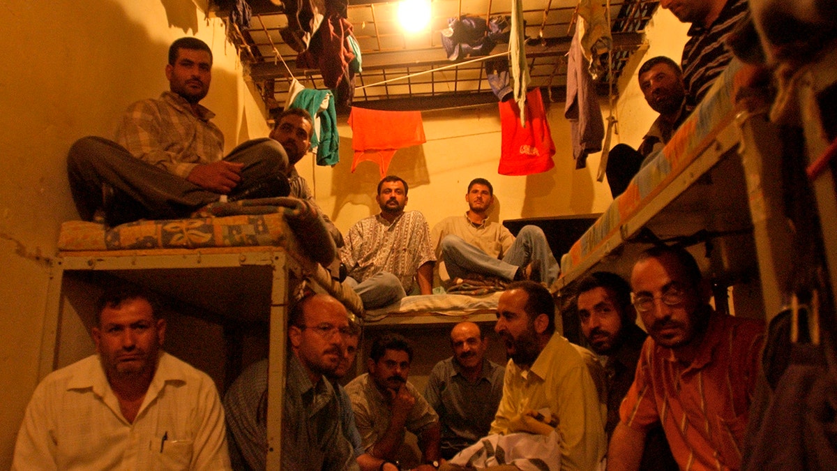 FILE - This Aug. 3, 2005 file photo, Lebanese ex-inmates of the notorious Khiam prison sit in their former cells where they displayed their belongings during a sit-in at the Khiam prison, in southern Lebanon.(AP Photo/Mohammad Zaatari, File)