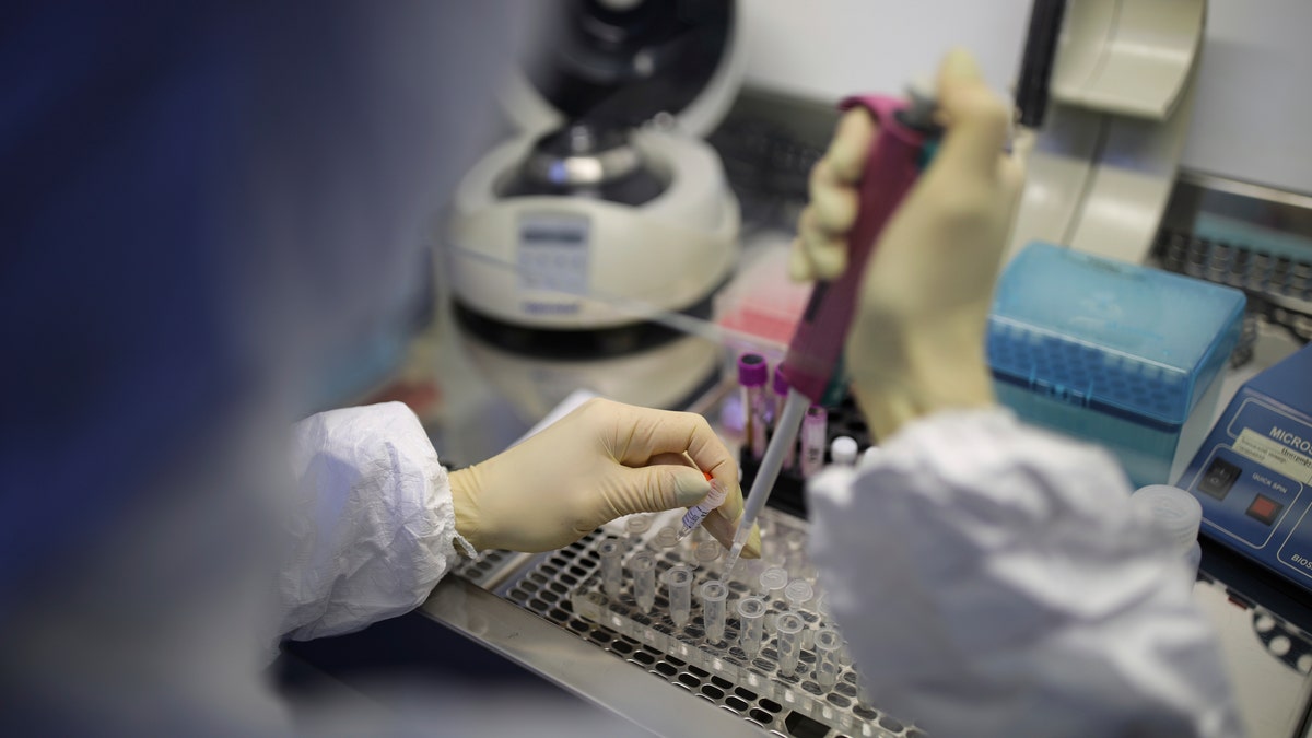 A medical staffer works with test systems for the diagnosis of coronavirus.