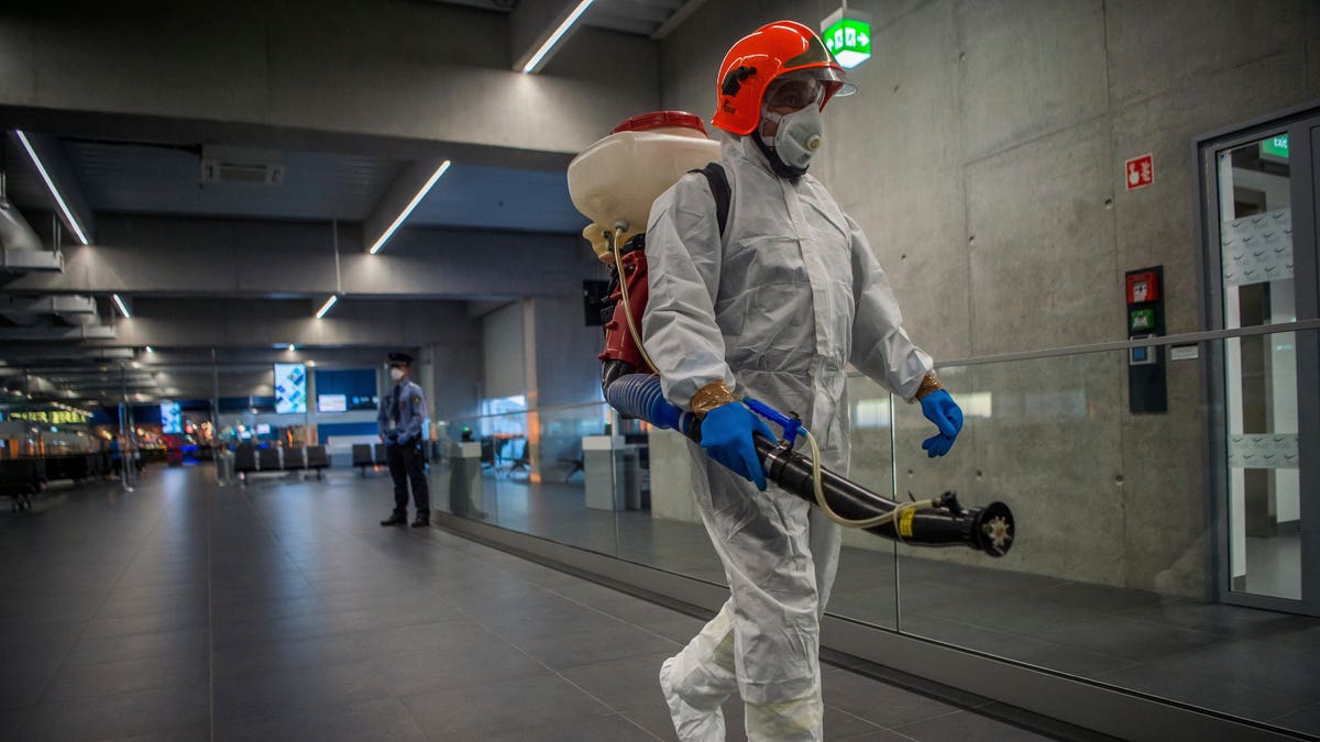 Disinfection equipment is carried by a worker as precautionary measures against the spreading of novel coronavirus, at Budapest Liszt Ferenc International Airport in Budapest, Hungary, Wednesday, Feb. 5, 2020. (Zoltan Balogh/MTI via AP)