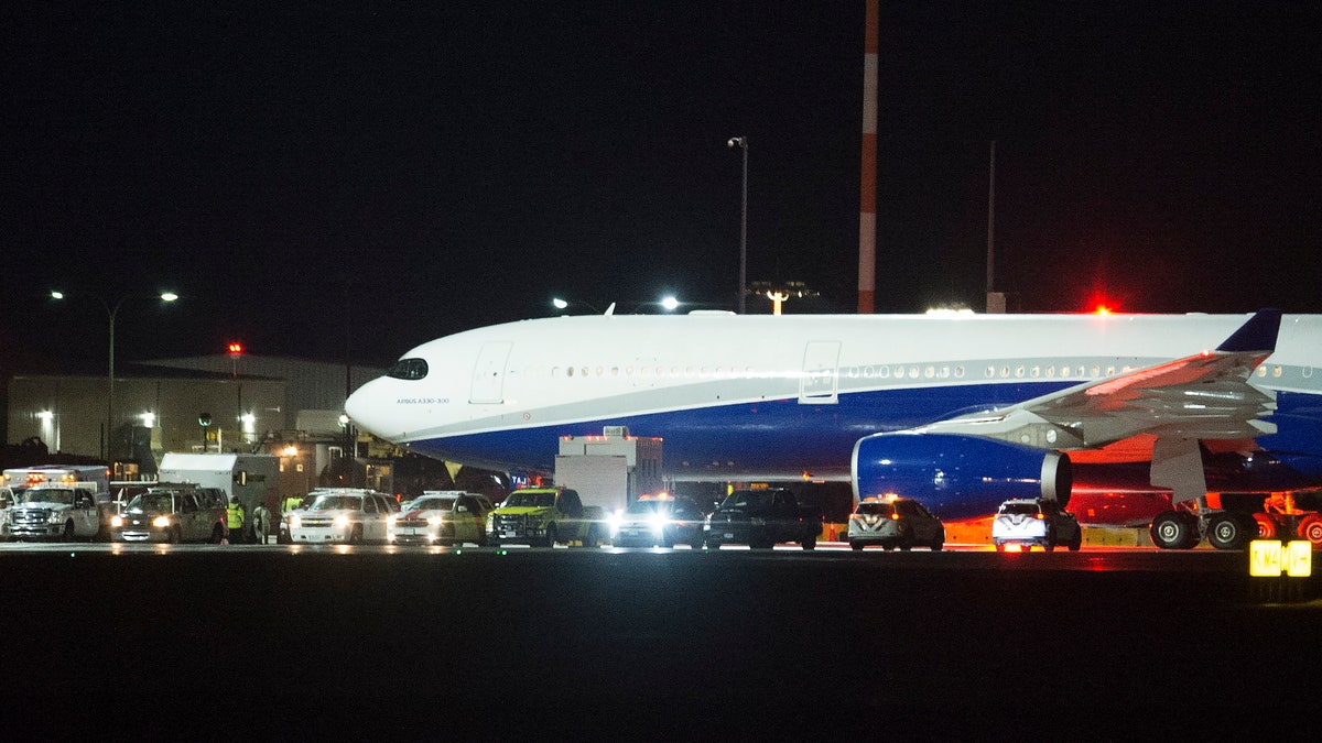 A plane carrying Canadians back from Wuhan, China, is pictured on the tarmac at Vancouver International Airport, in Richmond, British Columbia, Thursday, Feb. 6, 2020. (Jonathan Hayward/The Canadian Press via AP)