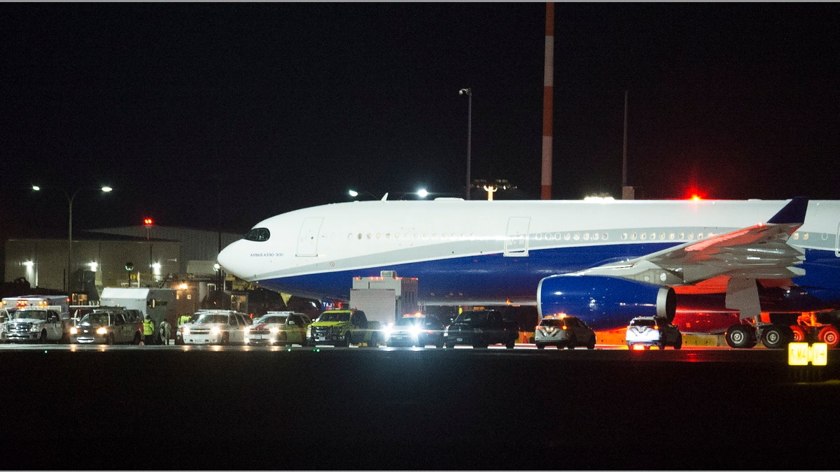 A plane carrying Canadians back from Wuhan, China, is pictured on the tarmac at Vancouver International Airport, in Richmond, British Columbia, Thursday, Feb. 6, 2020. (Jonathan Hayward/The Canadian Press via AP)