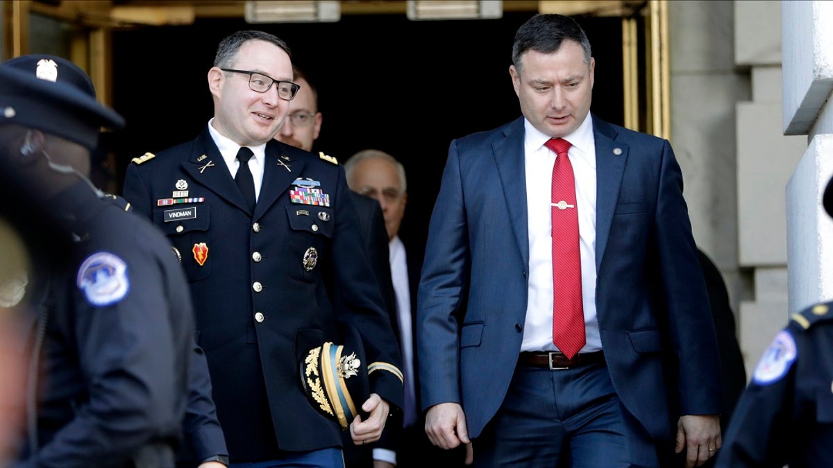 Lt. Col. Alexander Vindman, left, walks with his twin brother, Army Lt. Col. Yevgeny Vindman, in November 2019 after testifying before the House Intelligence Committee. (AP Photo/Julio Cortez, File)