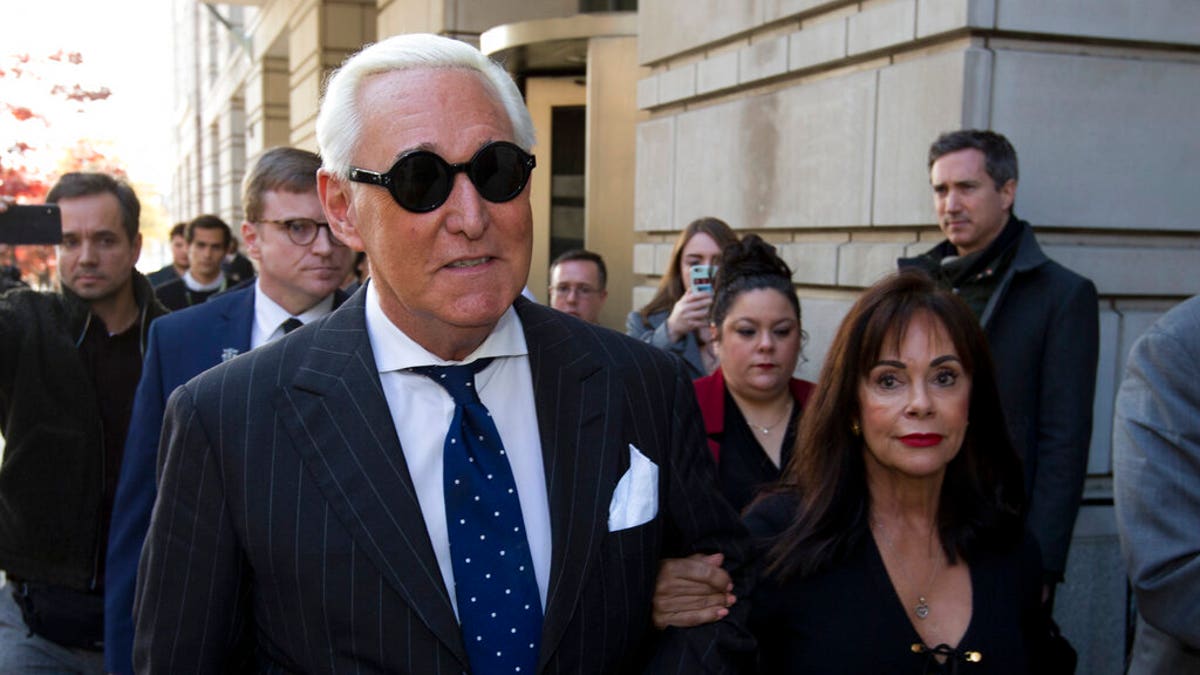 FILE - In this Nov. 15, 2019, file photo, Roger Stone, left, with his wife Nydia Stone, leaves federal court in Washington, Friday, Nov. 15, 2019. Federal prosecutors are asking a judge to sentence Stone to serve between 7 and 9 years in prison after his conviction on witness tampering and obstruction charges. (AP Photo/Jose Luis Magana, File)