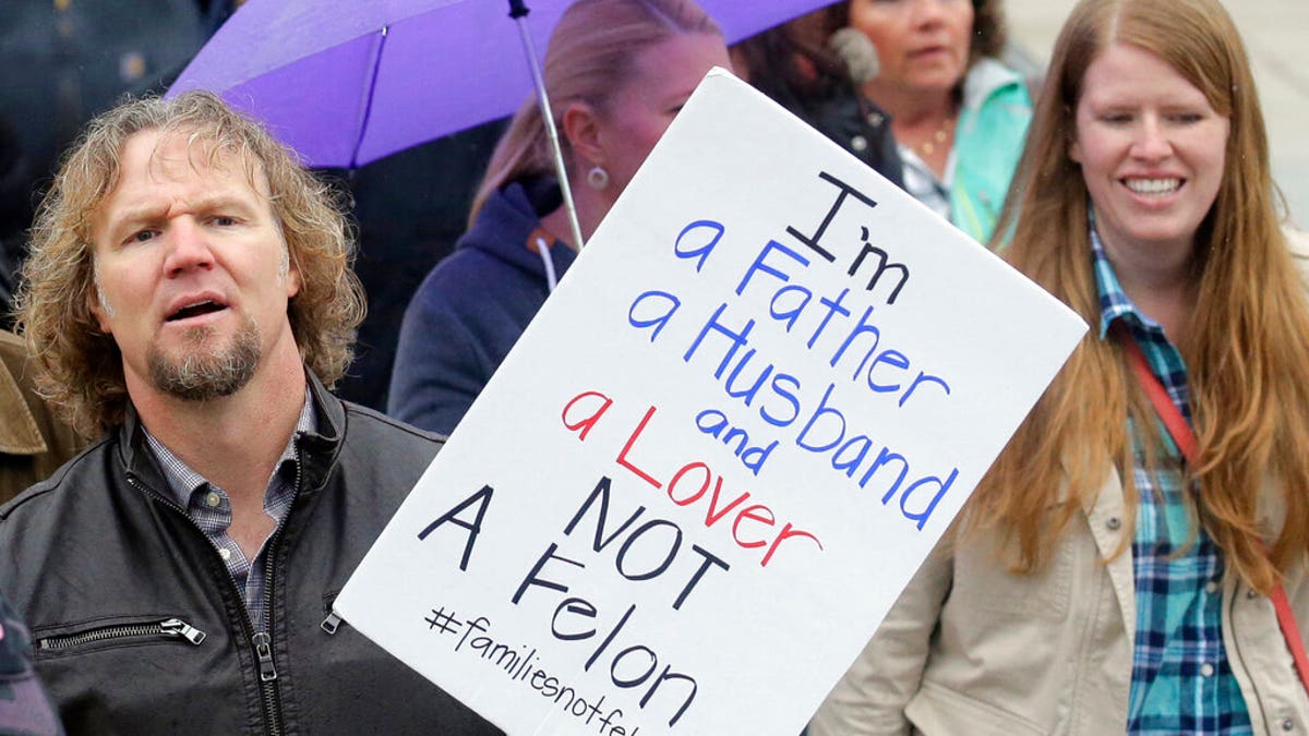 FILE: Kody Brown, left, from TV's reality show "Sister Wives," marches during a protest at the state Capitol, in Salt Lake City. 