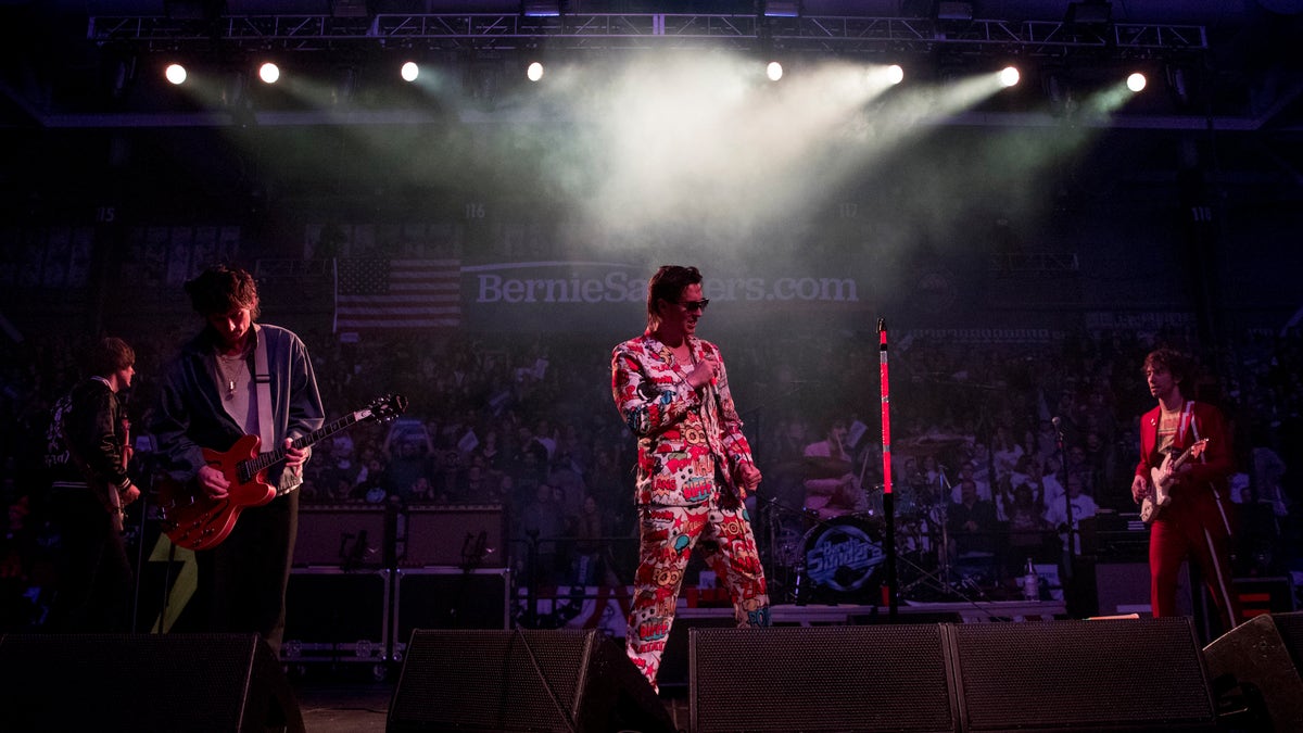 Julian Casablancas, lead singer of The Strokes, center, performs after Democratic presidential candidate Sen. Bernie Sanders, I-Vt., speaks at a campaign stop at the Whittemore Center Arena at the University of New Hampshire, Monday, Feb. 10, 2020, in Durham, N.H. (AP Photo/Andrew Harnik)