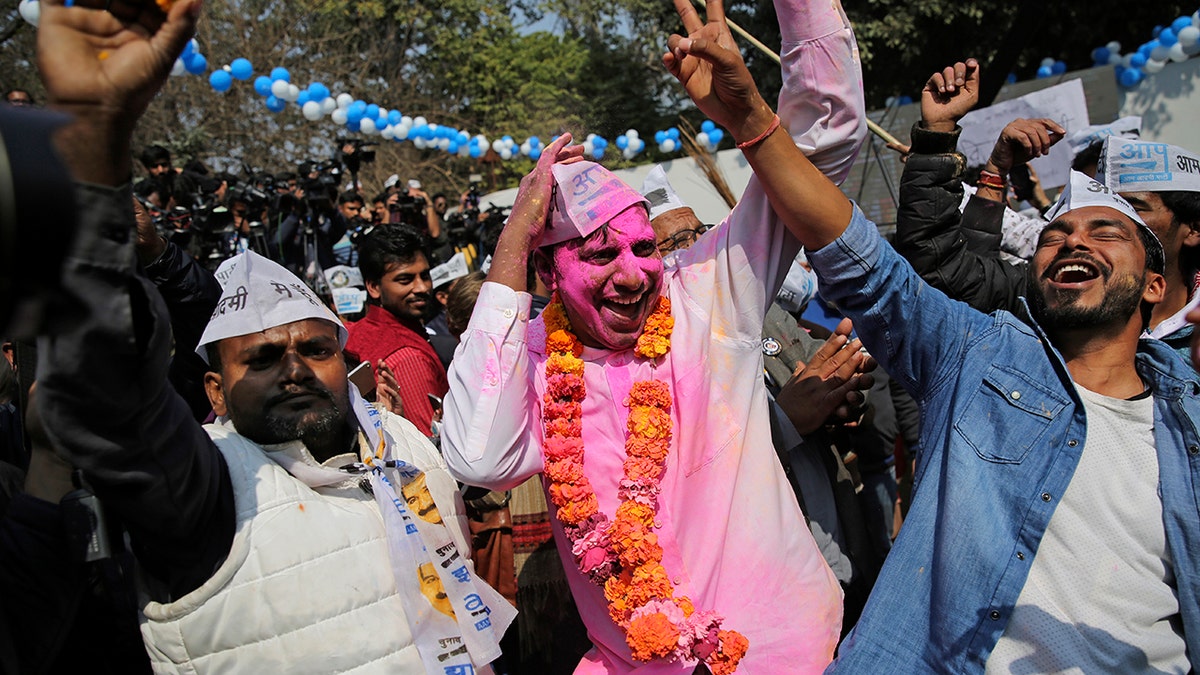 Supporters of the Aam Aadmi Party, or "common man's" party, celebrate the party's victory, at their party office in New Delhi, India, Tuesday, Feb. 11, 2020. Indian Prime Minister Narendra Modi’s Hindu nationalist party was facing a major defeat by the regional party Tuesday in elections in the national capital that were seen as a referendum on Modi's policies such as a new national citizenship law that excludes Muslims. (AP Photo/Altaf Qadri)