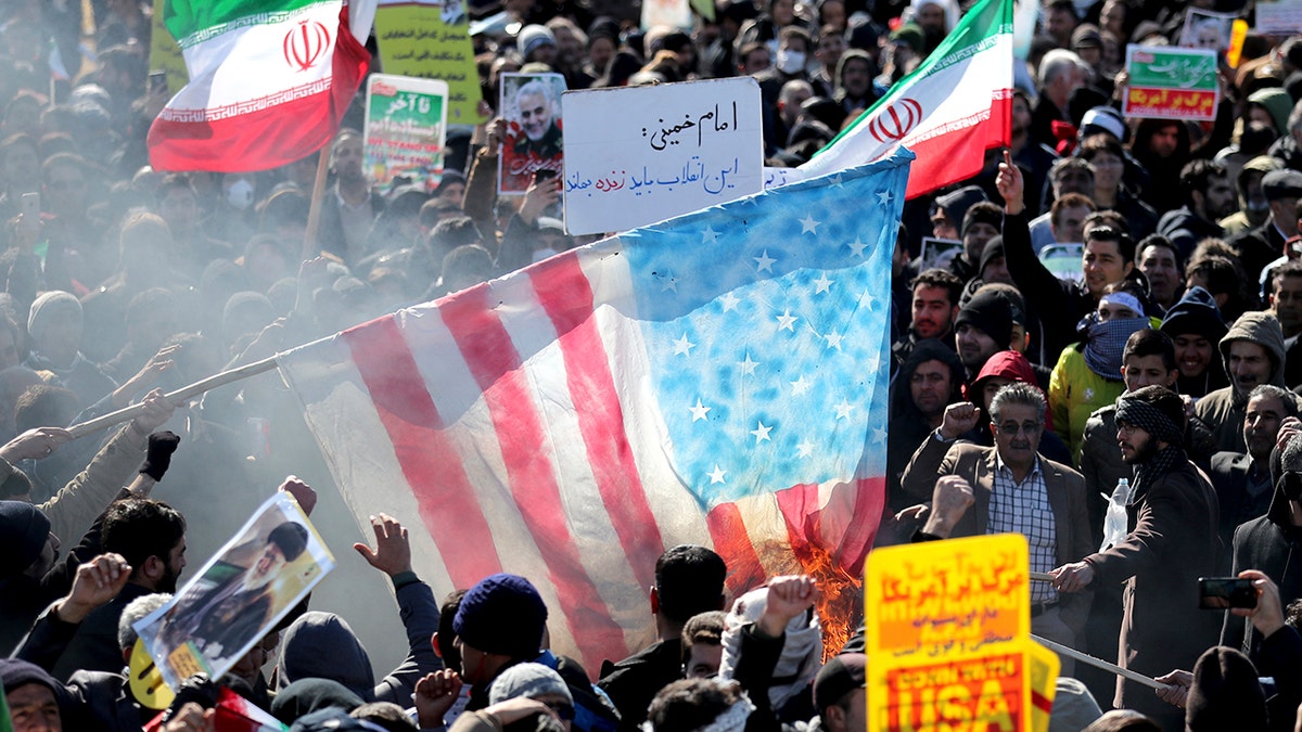 Iranians burn a U.S. flag during a rally at Azadi (Freedom) Square celebrating the 41st anniversary of the Islamic Revolution, in Tehran, Iran. (AP Photo/Ebrahim Noroozi)