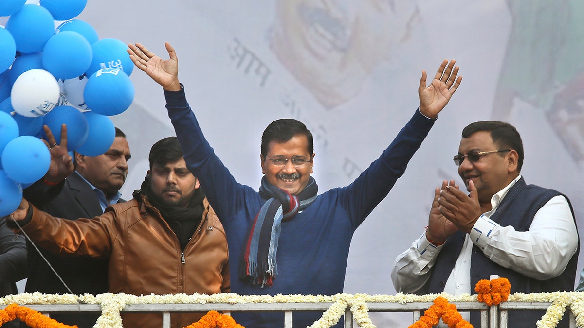 Incumbent Delhi Chief Minister Arvind Kejriwal, center, waves at Aam Aadmi Party, or "common man's" party headquarters as they celebrate the party's victory in New Delhi, India, Tuesday, Feb. 11, 2020. Indian Prime Minister Narendra Modi's Hindu nationalist party was facing a stunning defeat by a regional party Tuesday in elections in the national capital that were seen as a referendum on Modi's policies such as a new national citizenship law that excludes Muslims. (AP Photo/Manish Swarup)