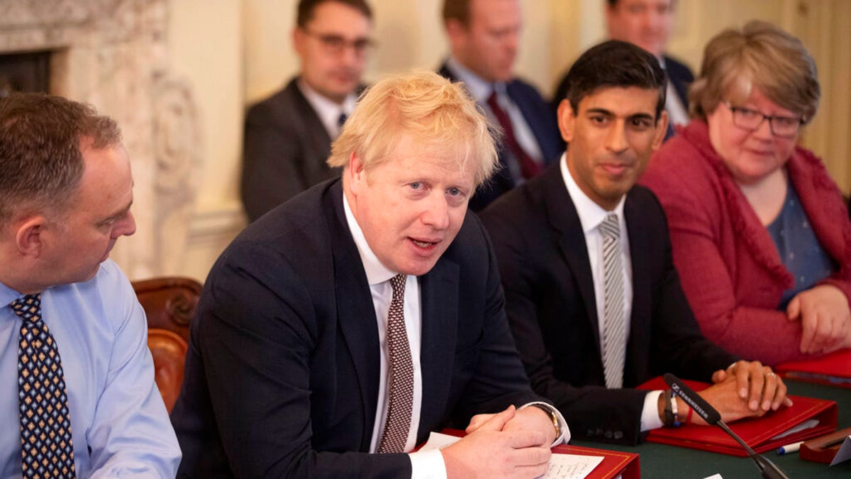 British Prime Minister Boris Johnson speaks during his first Cabinet meeting flanked by his new Chancellor of the Exchequer Rishi Sunak, centre right, after a reshuffle the day before, inside 10 Downing Street, in London, Friday, Feb. 14, 2020. 