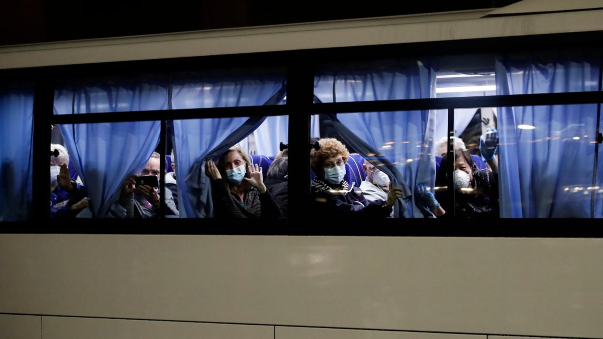 Buses carrying passengers from the quarantined Diamond Princess cruise ship leaving a port in Yokohama on Monday. (AP Photo/Jae C. Hong)