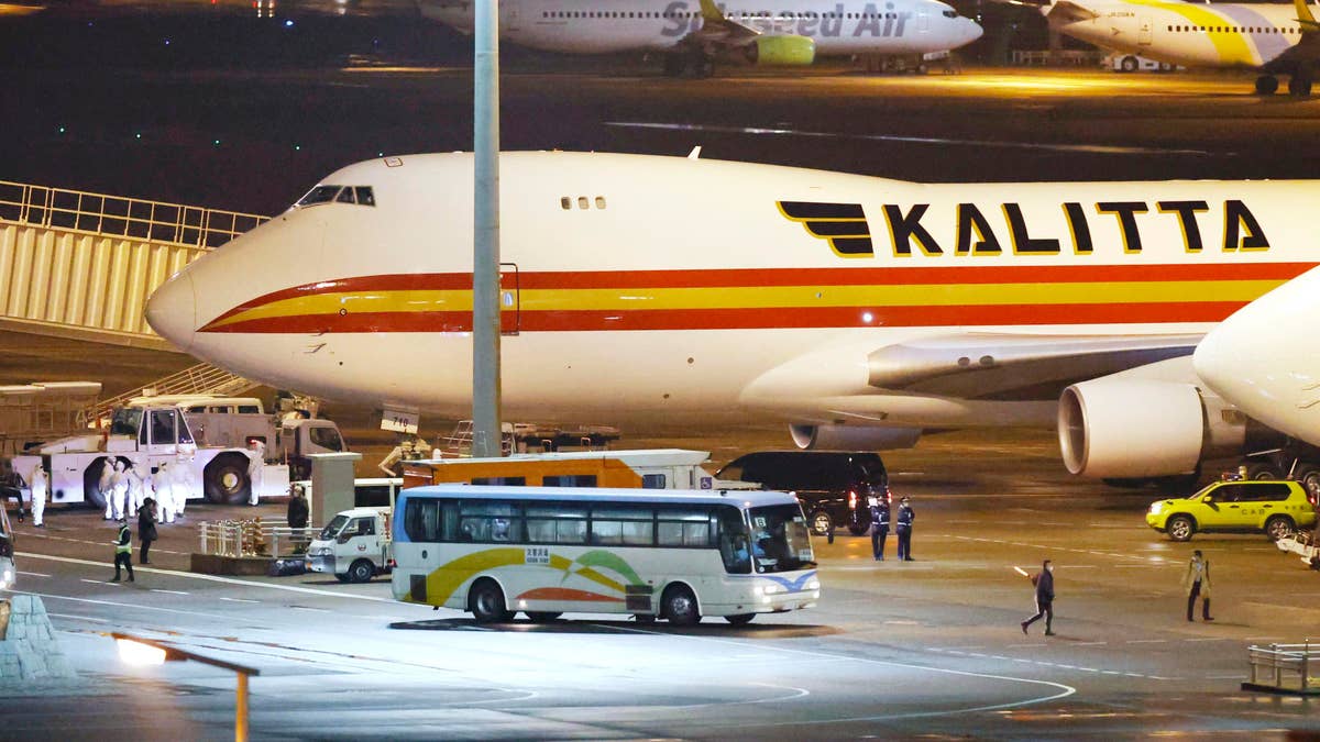 A bus carrying U.S. passengers who were aboard the quarantined cruise ship the Diamond Princess arriving at Haneda Airport in Tokyo. (Sadayuki Goto/Kyodo News via AP)
