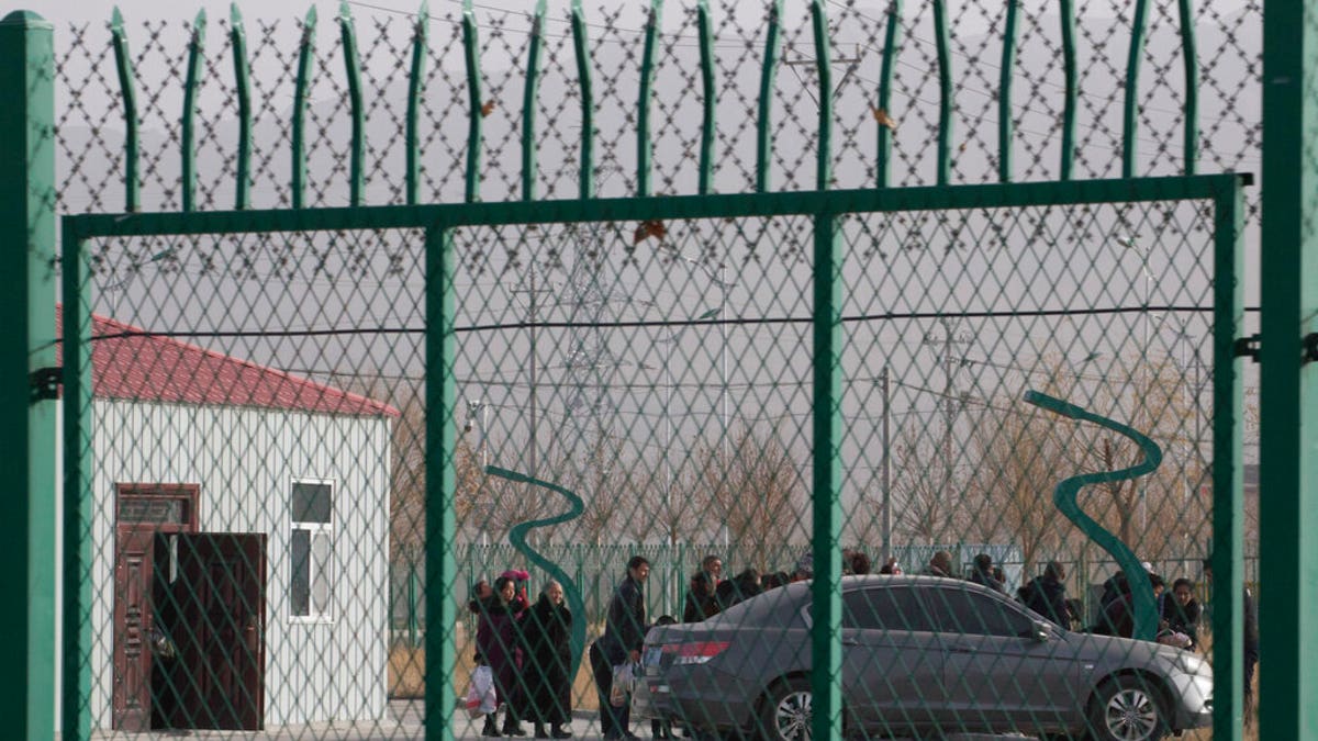 Residents line up inside the Artux City Vocational Skills Education Training Service Center which has previously been revealed by leaked documents to be a forced indoctrination camp at the Kunshan Industrial Park in Artux in western China's Xinjiang region.