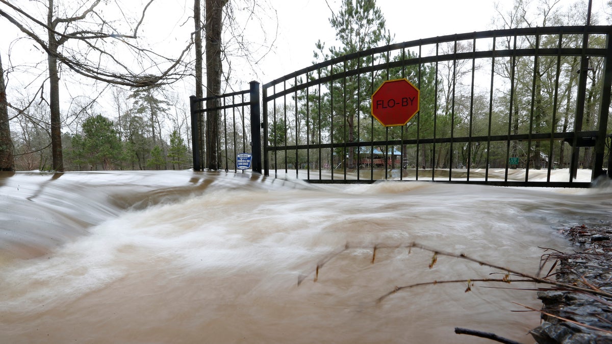This time exposure shows the strength of the Pearl River floodwaters on this residence on Florence-Byram Road near Byram, Miss., on Monday, Feb. 17, 2020. (AP Photo/Rogelio V. Solis)