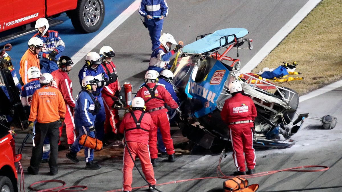 Rescue workers arriving to check on Ryan Newman after he was involved in a wreck on the last lap of the Daytona 500. (AP Photo/David Graham)