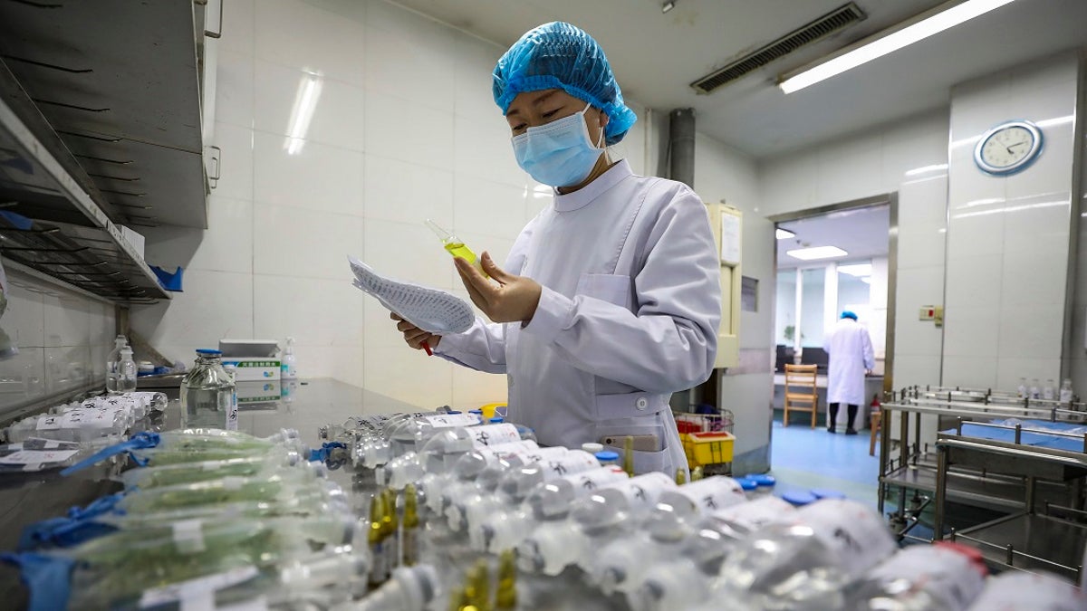 A nurse prepares medicines for patients at Jinyintan Hospital designated for new coronavirus infected patients, in Wuhan in central China's Hubei province. Blood supplies in several Chinese cities are reporting shortages amid travel restrictions that keep potential donors at home. (Chinatopix via AP)