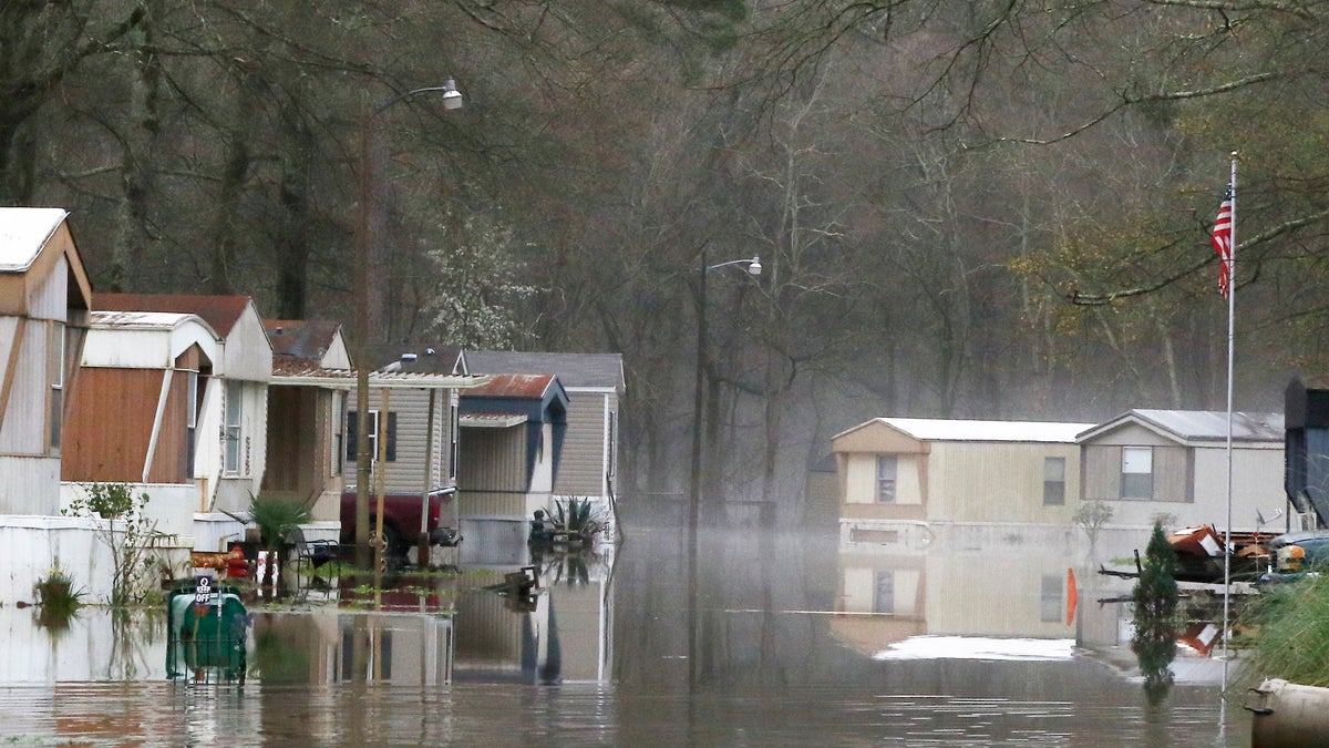 Standing floodwater from the Pearl River still surrounds a number of mobile homes in the back portion of the Harbor Pines community in Ridgeland, Miss., Tuesday, Feb. 18, 2020.  (AP Photo/Rogelio V. Solis)
