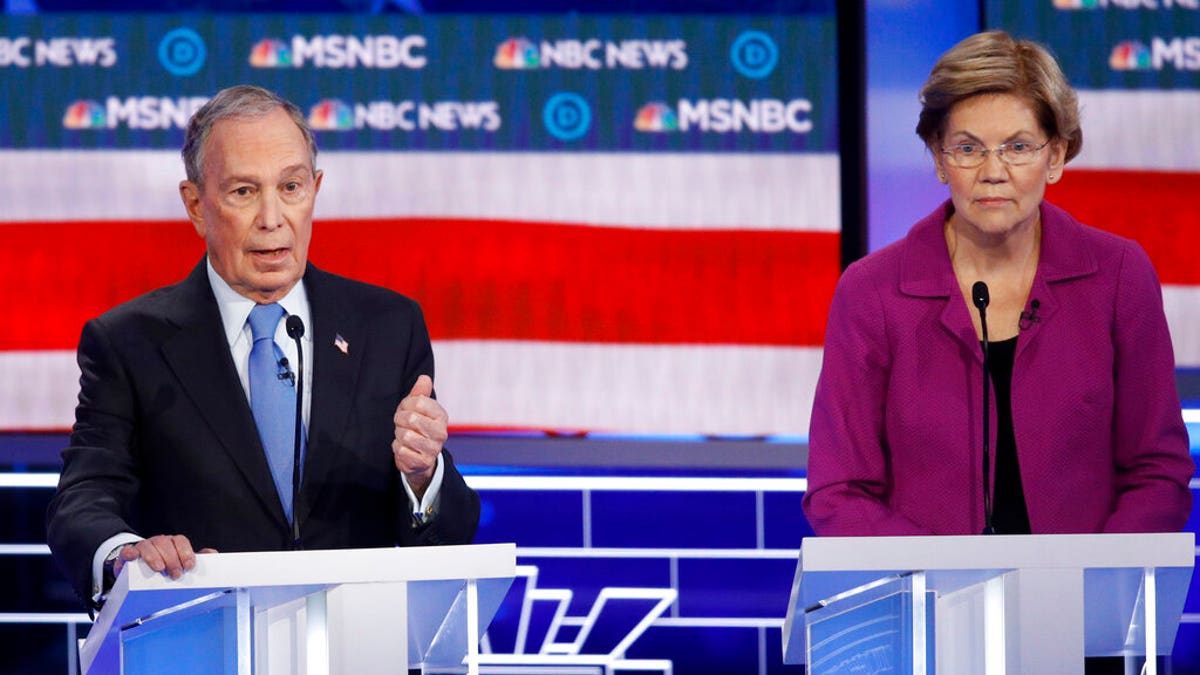 Democratic presidential candidates, former New York City Mayor Mike Bloomberg, left, speaks as Sen. Elizabeth Warren, D-Mass., looks on during a Democratic presidential primary debate Wednesday, Feb. 19, 2020, in Las Vegas, hosted by NBC News and MSNBC. (AP Photo/John Locher)