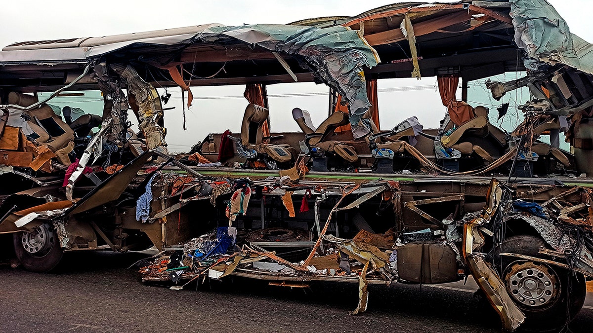 The remains of a Kerala state-run bus that collided head-on with a truck near Avanashi, Tamil Nadu state, India, Thursday, Feb. 20, 2020. At least 19 people were killed and more than 20 were injured in the accident. (AP Photo)