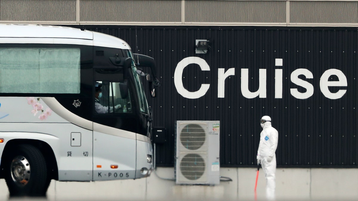 A bus carrying passengers from the quarantined Diamond Princess cruise ship prepares to leave a port in Yokohama, near Tokyo, Thursday, Feb. 20, 2020. (Associated Press)