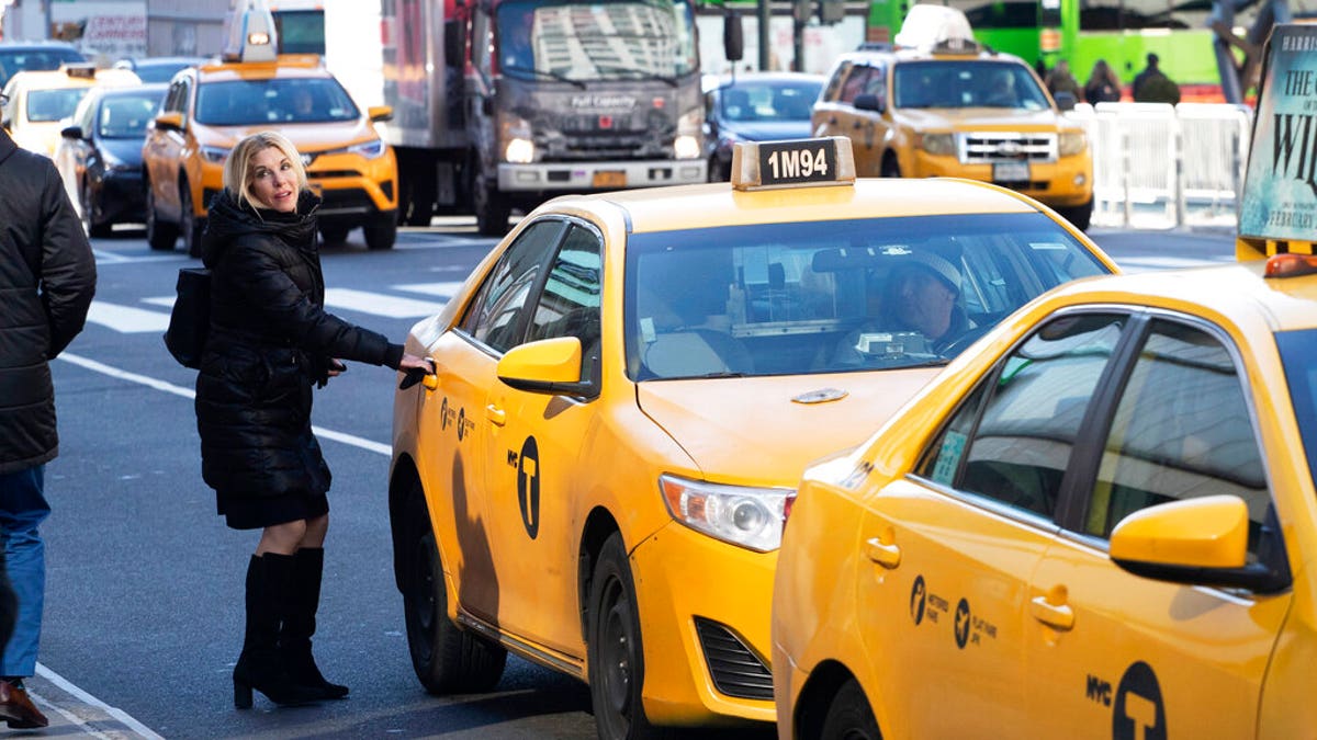 A passenger gets into a taxi in New York. 