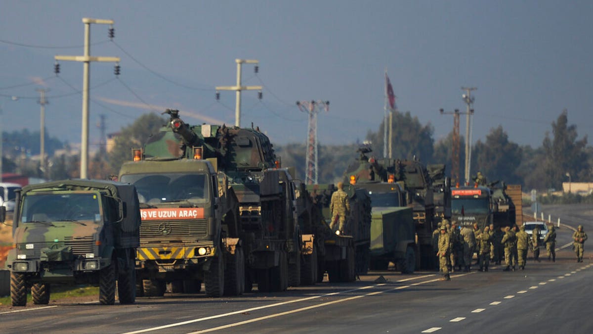 FILE - In this Feb. 14, 2020, file photo, Turkish troops and artillery prepare to enter Syria, in Reyhanli, Hatay, Turkey. (AP Photo, File)