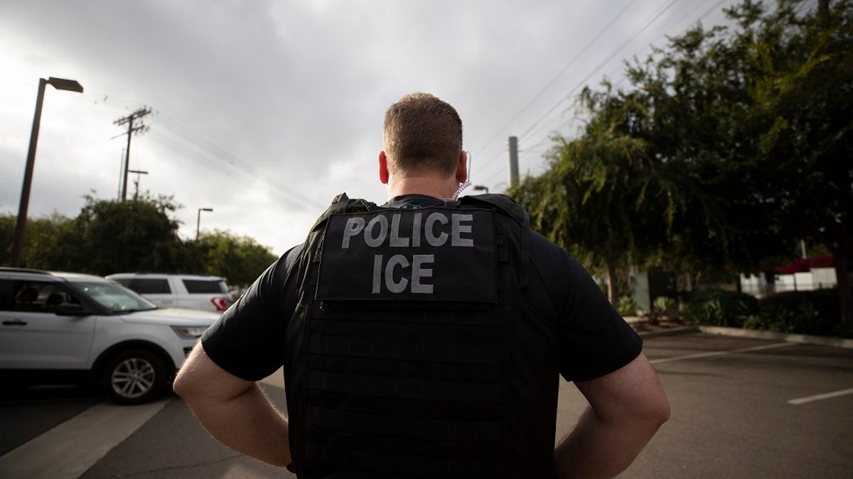 A U.S. Immigration and Customs Enforcement (ICE) officer looks on during an operation in Escondido, Calif. (Associated Press)