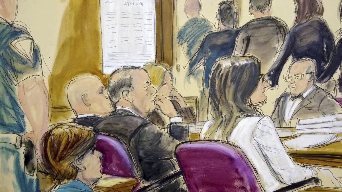 In this courtroom drawing, Harvey Weinstein, center, sits at the defense table surrounded by his attorneys as jurors file out of the courtroom after being told by the judge to go back and keep deliberating in Weinstein's rape case, Friday, Feb. 21, 2020, at Manhattan Supreme Court in New York.