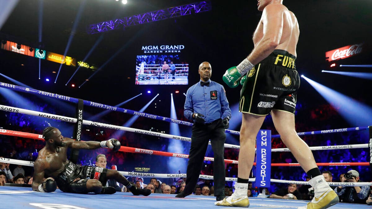 Tyson Fury, of England, knocks down Deontay Wilder during a WBC heavyweight championship boxing match Saturday, Feb. 22, 2020, in Las Vegas.