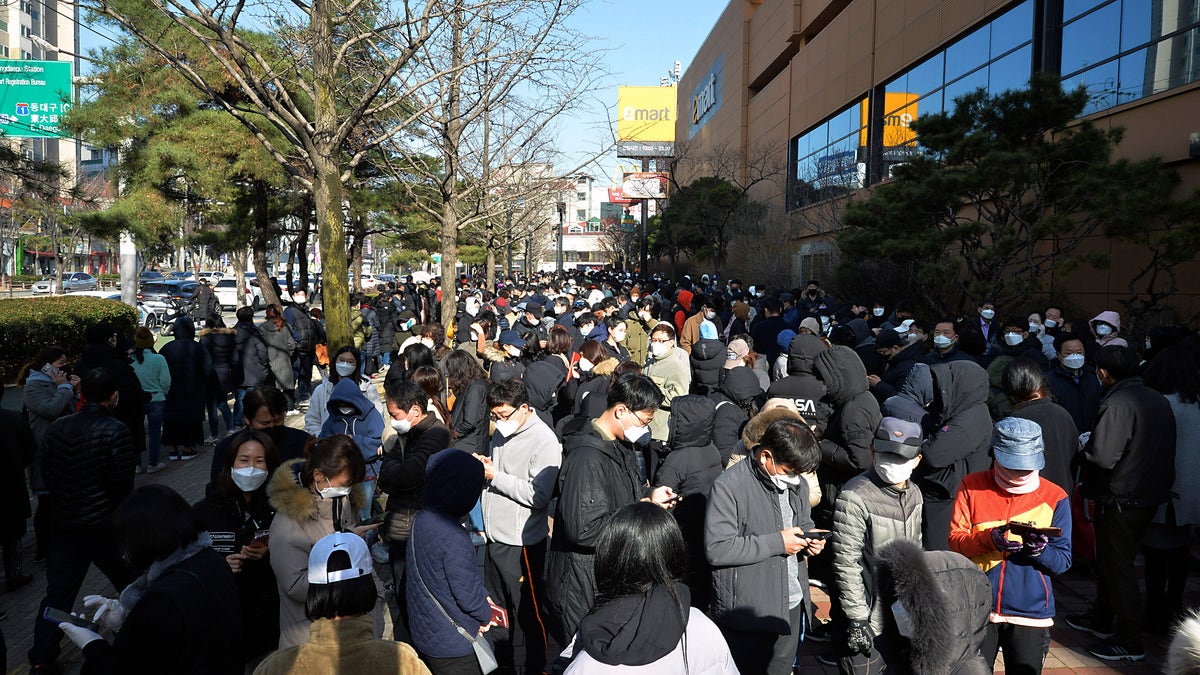 People line up to buy face masks at a store in Daegu, South Korea, Monday, Feb. 24, 2020. South Korea's President Moon Jae-in on Sunday put the country on its highest alert for infectious diseases and says officials should take "unprecedented, powerful" steps to fight a viral outbreak. (Lee Moo-ryul/Newsis via AP)