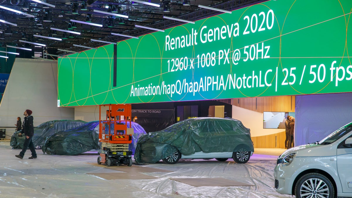 Cars are pictured as workers stop the preparation of the 90th Geneva International Motor Show, GIMS, at Palexpo, in Geneva, Switzerland, Friday, Feb. 28, 2020. (Salvatore di Nolfi/Keystone via AP)