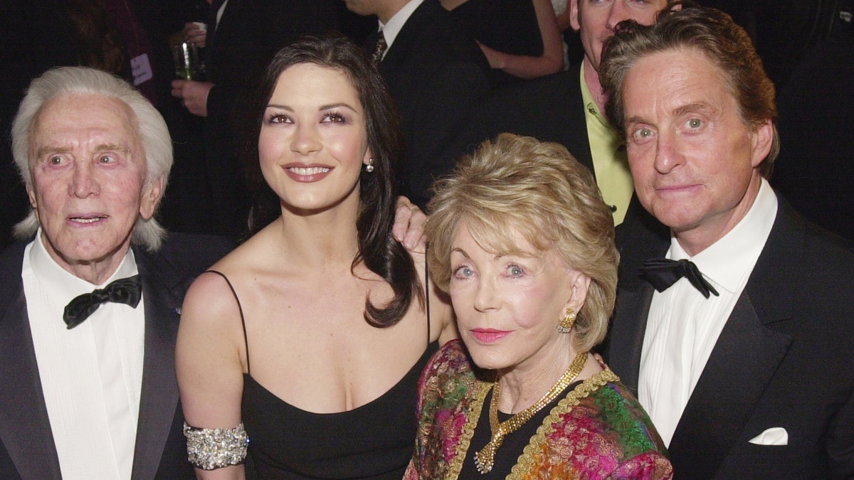 Kirk Douglas, Catherine Zeta-Jones, Anne Douglas, and Michael Douglas arrive at 'An Unforgettable Evening' presented by Saks Fifth Avenue benefitting Cedars-Sinai Medical Center March 27, 2001, at the Regent Beverly Wilshire Hotel in Beverly Hills, CA.