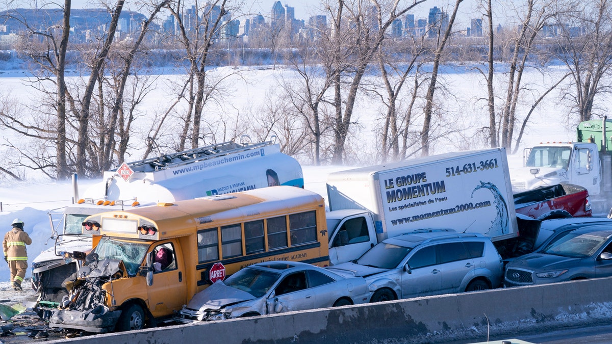 Emergency personnel gather at the scene following a multi-vehicle crash on the south shore of Montreal in La Prairie, Quebec, Wednesday, Feb. 19, 2020.