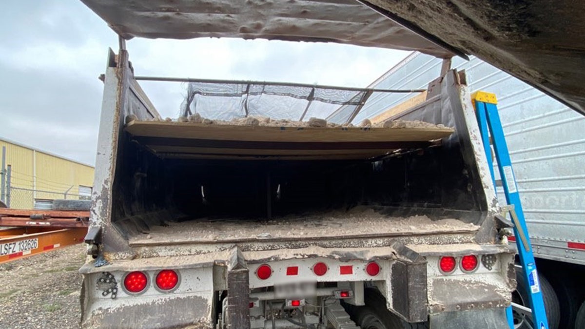 CBP officials found 36 migrants hidden beneath a compartment that created the impression that the truck was filled with gravel and dirt.