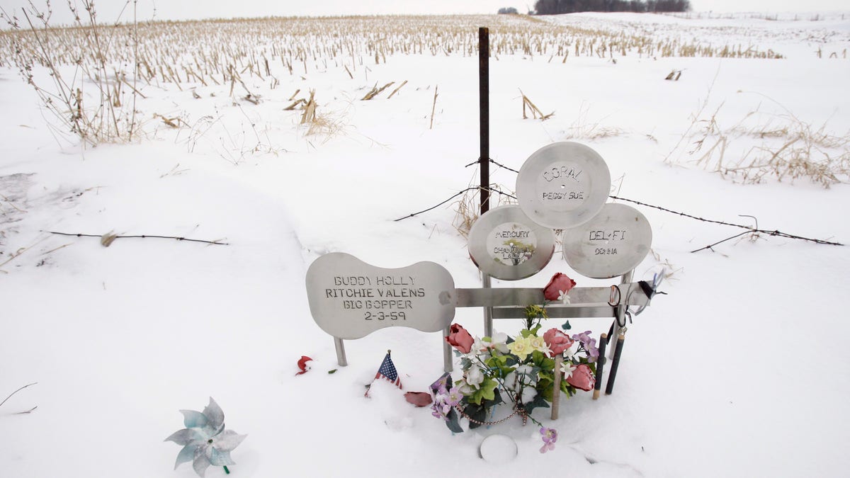 In this Friday, Jan. 9, 2009 file photo, flowers adorn a memorial at the spot where the plane carrying Buddy Holly, Ritchie Valens and J.P. "The Big Bopper" Richardson crashed, killing all aboard on Feb. 3, 1959, near Clear Lake, Iowa. The three young singers were in a single-engine aircraft flying in a light snowstorm in 1959 when the pilot apparently lost control. Holly decided to fly because his tour bus was having heating problems.