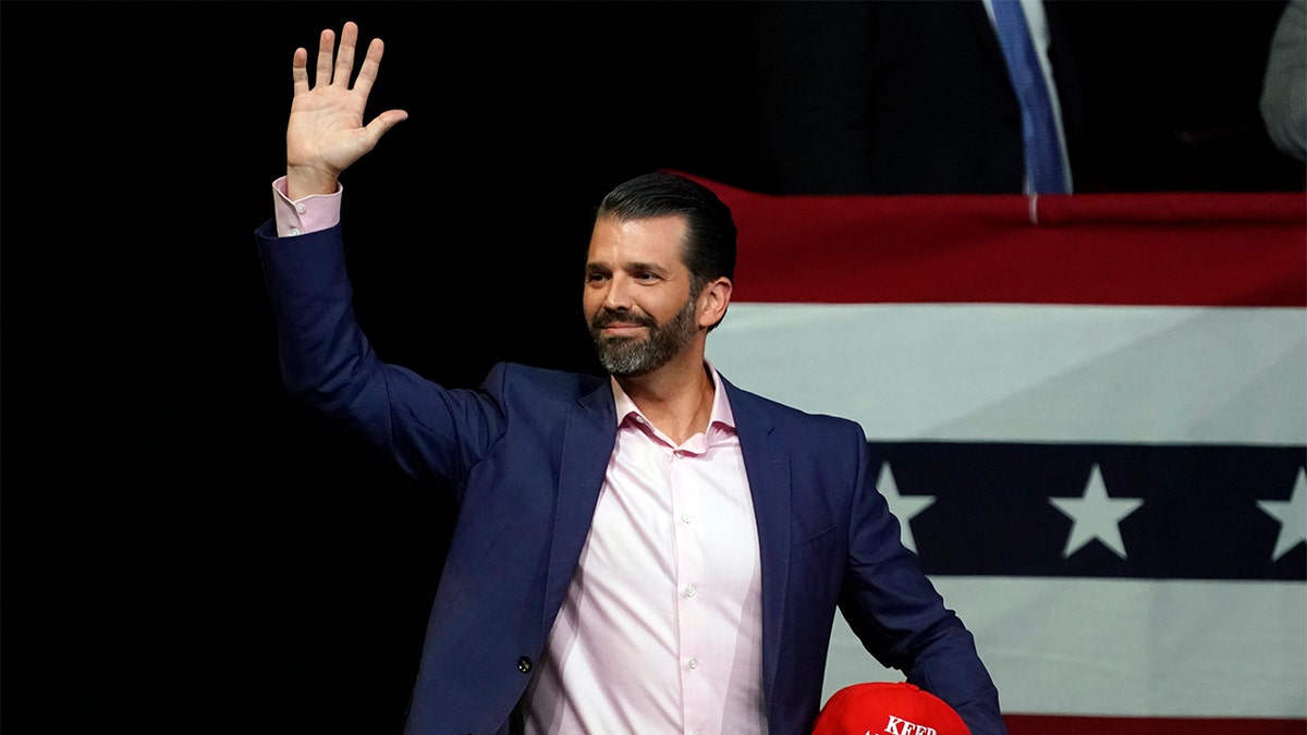 Donald Trump Jr. waves at campaign rally before President Donald Trump appears Wednesday, Feb. 19, 2020 in Phoenix. (AP Photo/Rick Scuteri)