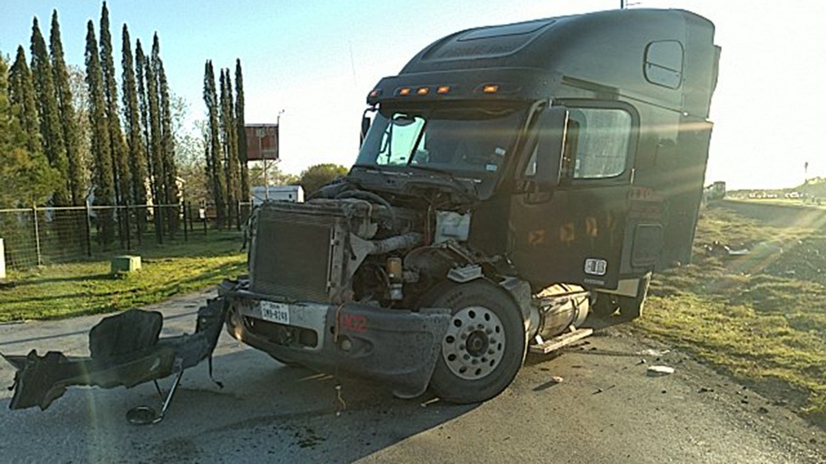 A black tractor-trailer stuck on railroad tracks in Texas was hit by am Amtrak train.