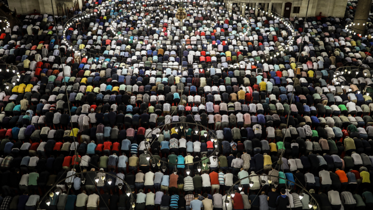 Turkey's Muslims offer prayers during the first day of Eid al-Fitr, which marks the end of the holy fasting month of Ramadan, at the Suleymaniye Mosque in Istanbul, early Tuesday, June 4, 2019. (AP Photo/Emrah Gurel)