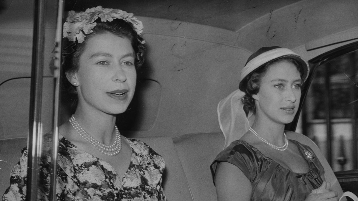 Queen Elizabeth II, left, and Princess Margaret. (Photo by PA Images via Getty Images)