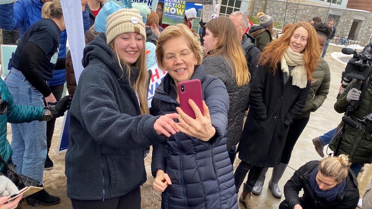 Sen. Elizabeth Warren of Massachusetts taking selfies with supporters at the University of New Hampshire on primary day, in Durham, N.H.