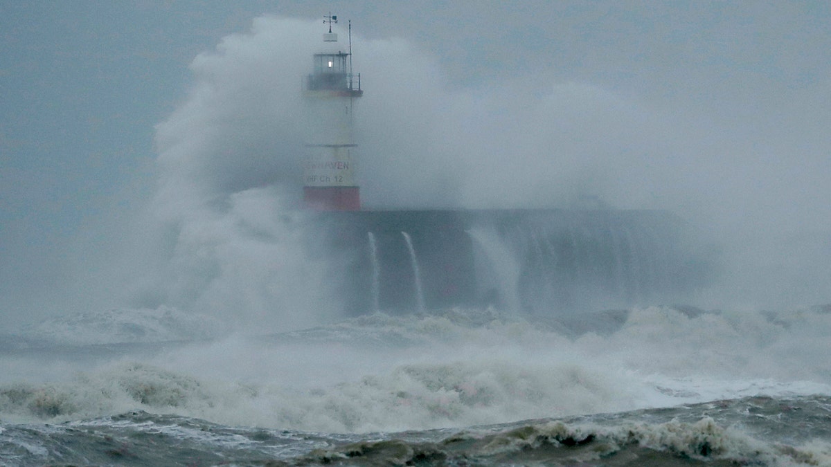 Waves crash over the harbour and a lighthouse, as Storm Ciara hits Newhaven, on the south coast of England, Sunday, Feb. 9, 2020.
