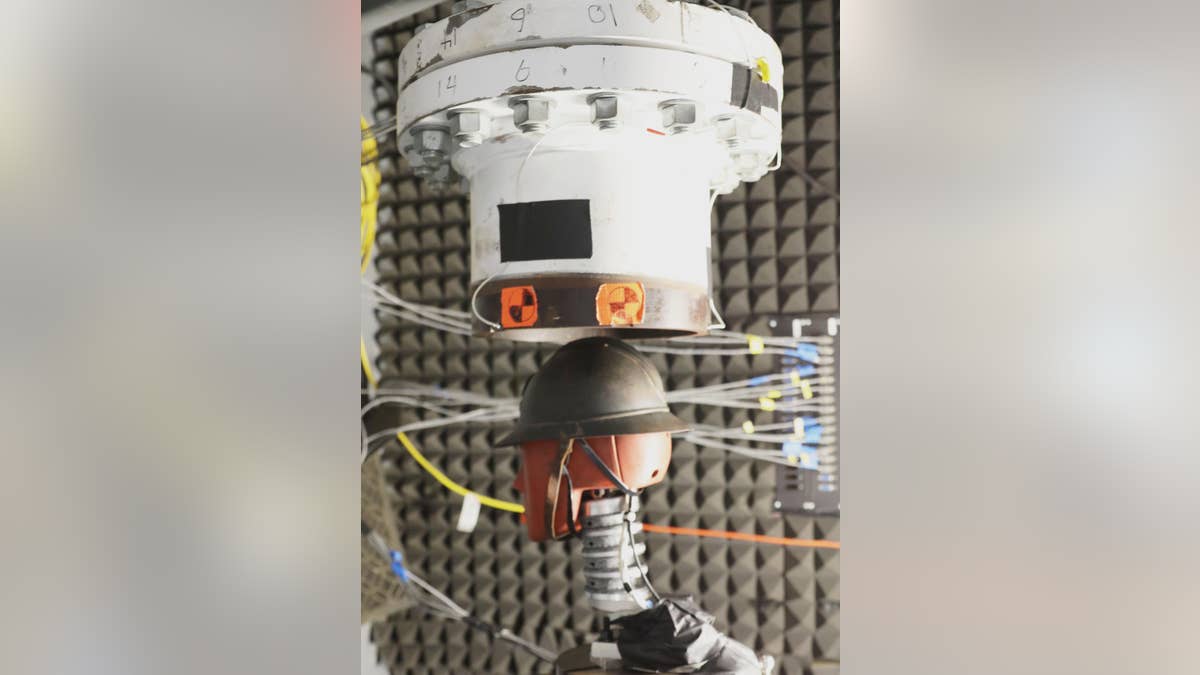 A French World War I Adrian helmet sits beneath a shock tube to test how well it protects the dummy underneath from a shock wave. The ridge down the center of the helmet, which was designed for deflecting shrapnel, but may well have also helped deflect shock waves, scientists say.