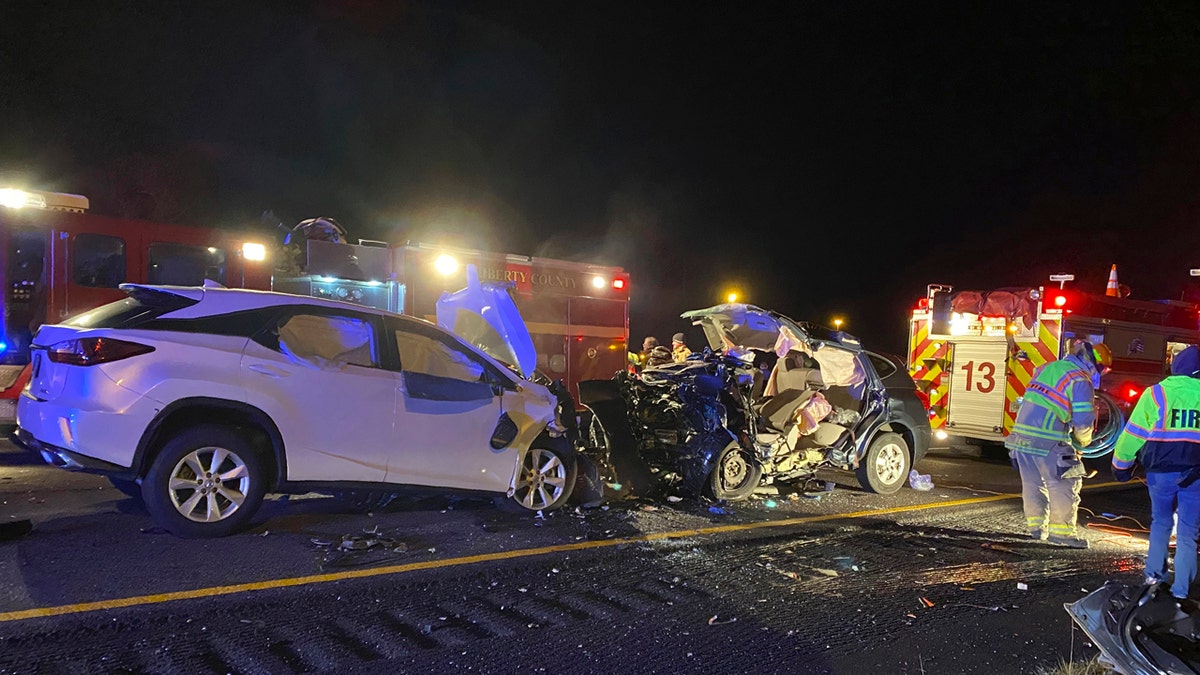First responders from the Midway Fire Department survey the scene of a fatal accident on Interstate 95, which claimed the lives of multiple people, early Sunday morning, Feb. 23, 2020, in Liberty County, Ga.