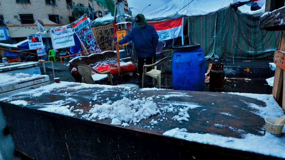 Fresh snow falls in Tahrir Square while anti-government protesters stage a sit-in in Baghdad, Iraq, Tuesday, Feb. 11, 2020.