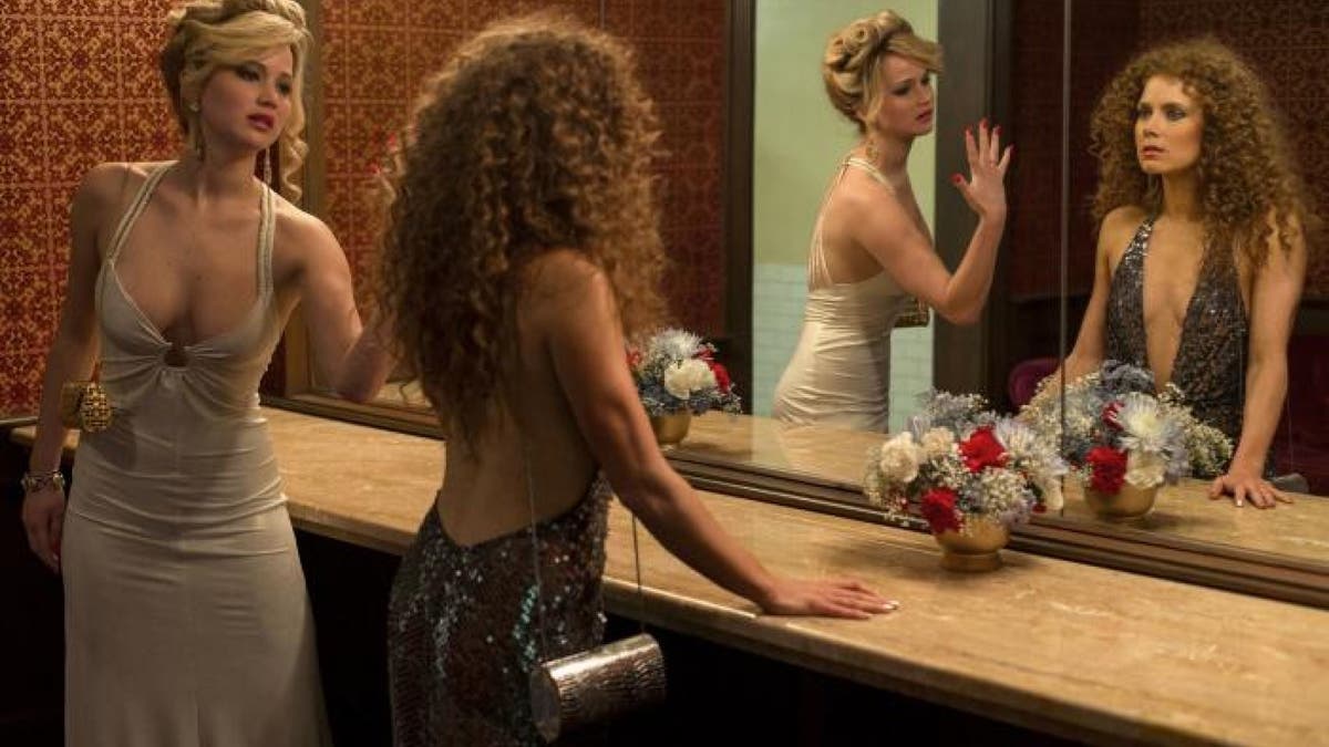 Michael Wilkinson, the costume designer for "American Hustle," claimed that Jennifer Lawrence (left) got Doritos dust all over the metallic white dress she wore in a climactic scene. 