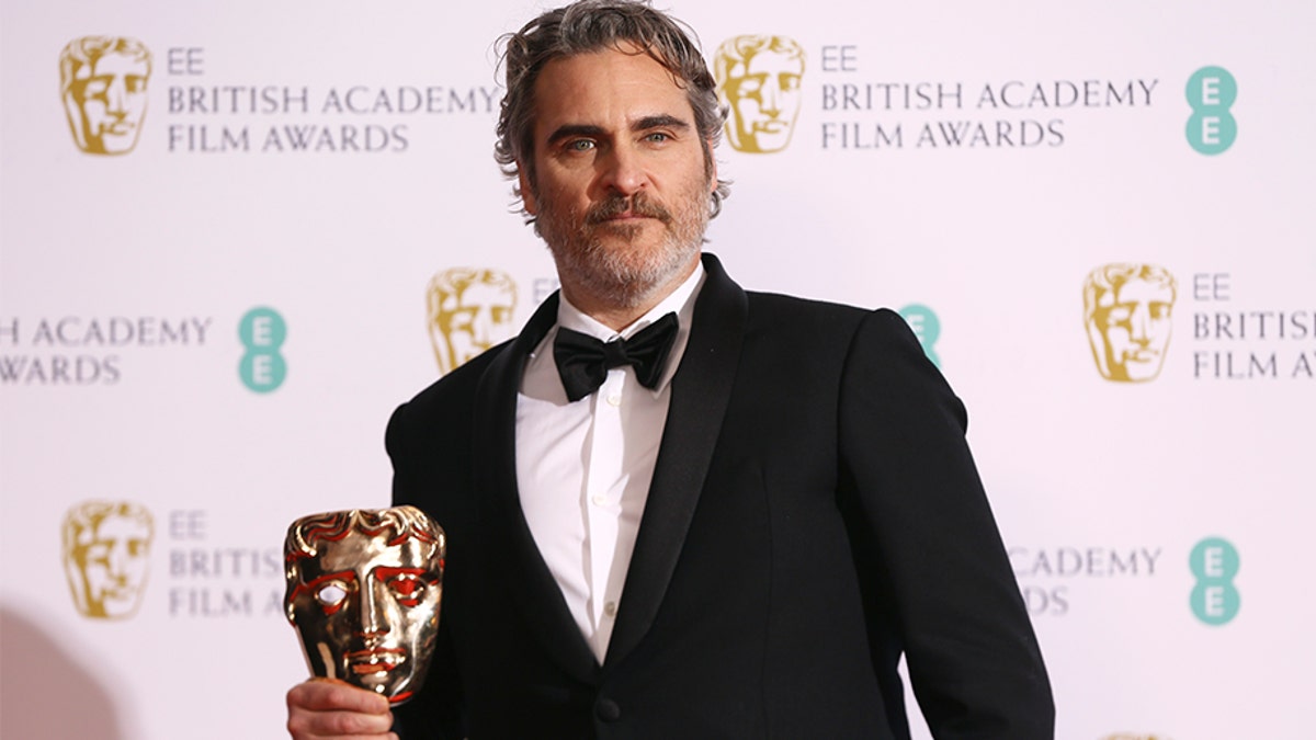 Joaquin Phoenix poses with his award for Best Actor for the film Joker, backstage at the Bafta Film Awards, in central London, Sunday, Feb. 2, 2020. (Photo by Joel C Ryan/Invision/AP)
