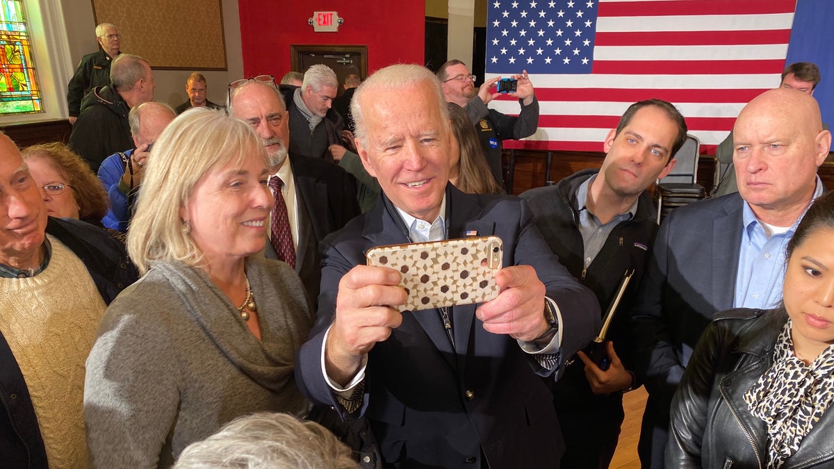Former Vice President Joe Biden takes selfies with supporters during a campaign event in Somersworth, N.H. on Feb. 5, 2020
